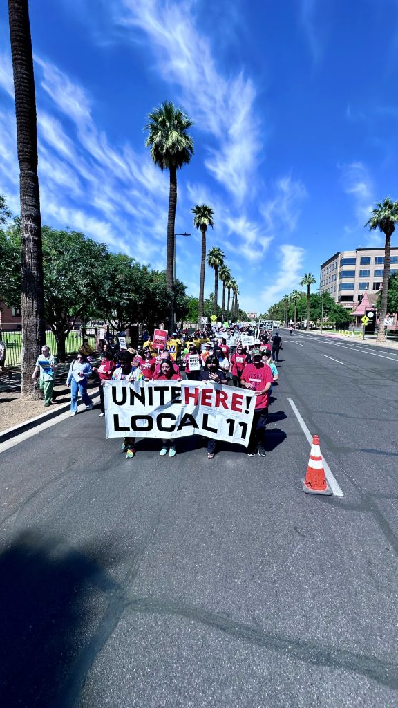 Front of protest march with a sign "UNITE HERE!" "LOCAL 11" on Washington street.